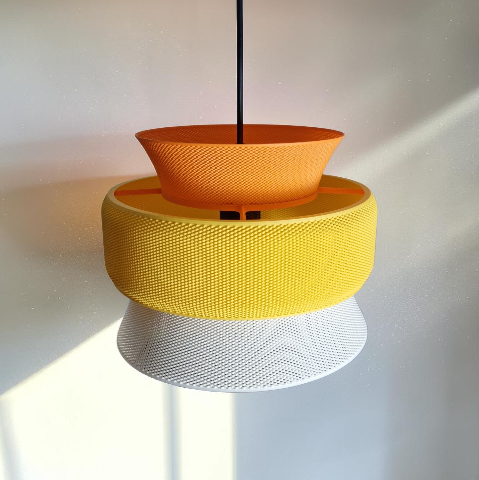  SAN pendant lampshade in plant-based bioplastic, close-up of textured surface showing orange yellow and white sections, low angle view