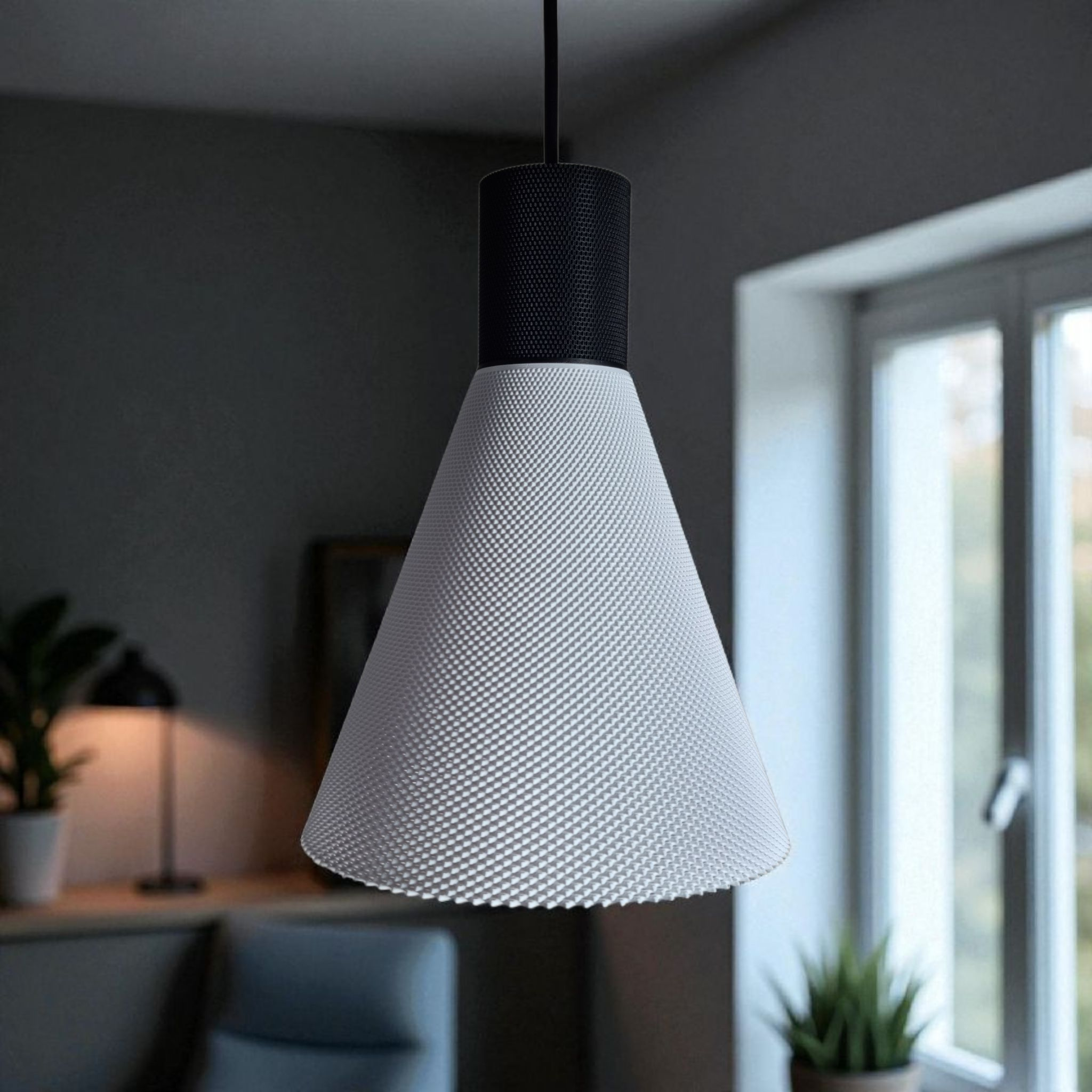 A modern pendant light with a conical white shade featuring a textured surface hangs from a black ceiling fixture. The background includes a well-lit room with a plant and a desk lamp, enhancing the contemporary ambiance.