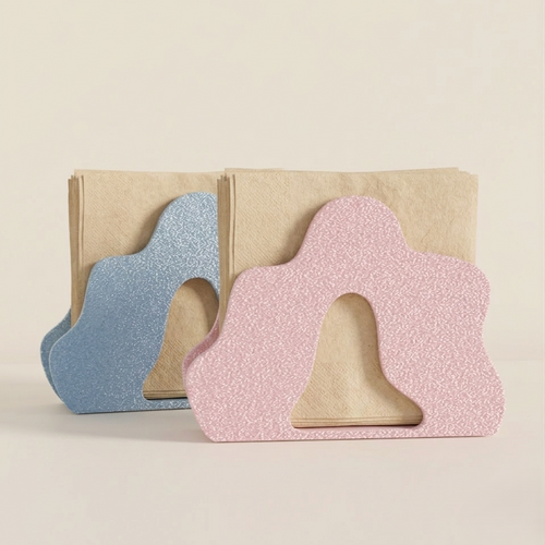 Two colorful napkin holders are displayed side by side, one in a soft blue shade and the other in a pastel pink.
