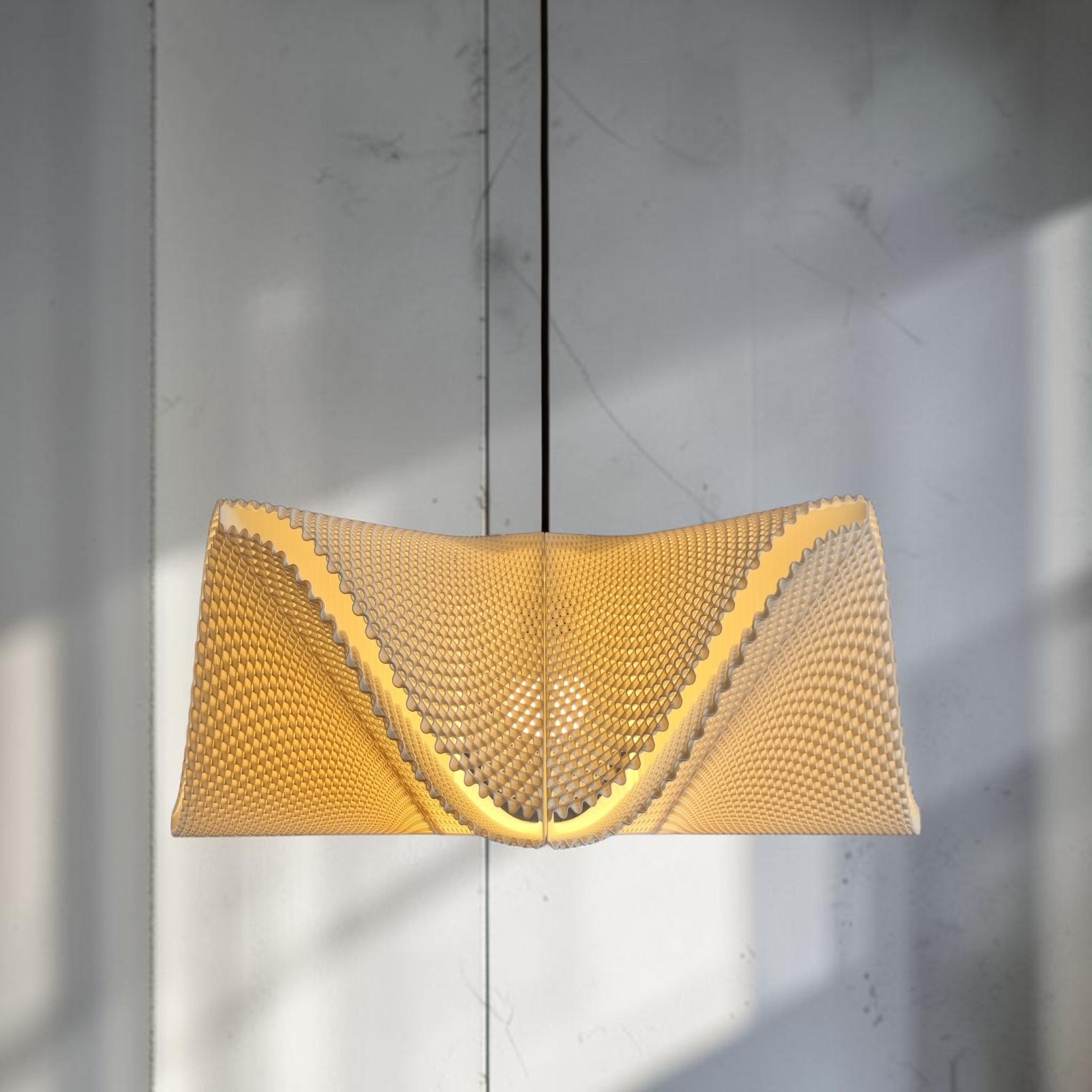 SINE pendant light glowing warm, 3D printed lampshade with fine ribbed texture, minimalist lighting design.