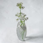 Transparent TEXTURIA vase filled with water and fresh white gypsophila flowers, showcasing its watertight design for fresh floral arrangements