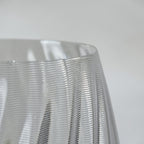 Close-up of the TEXTURIA Cristal vase rim, highlighting the spiral ribbed texture and glossy transparent finish that mimics blown glass